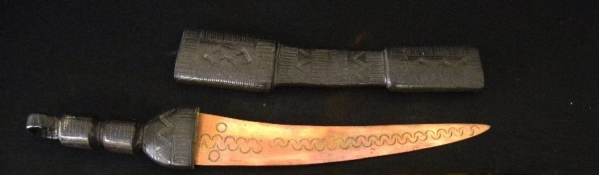 Dagger with leather sheath, curved and engraved blade
