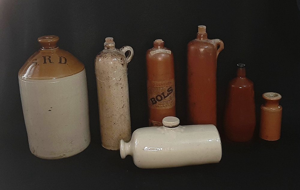 6 Earthenware storage bottles and old foot warmer (1d)