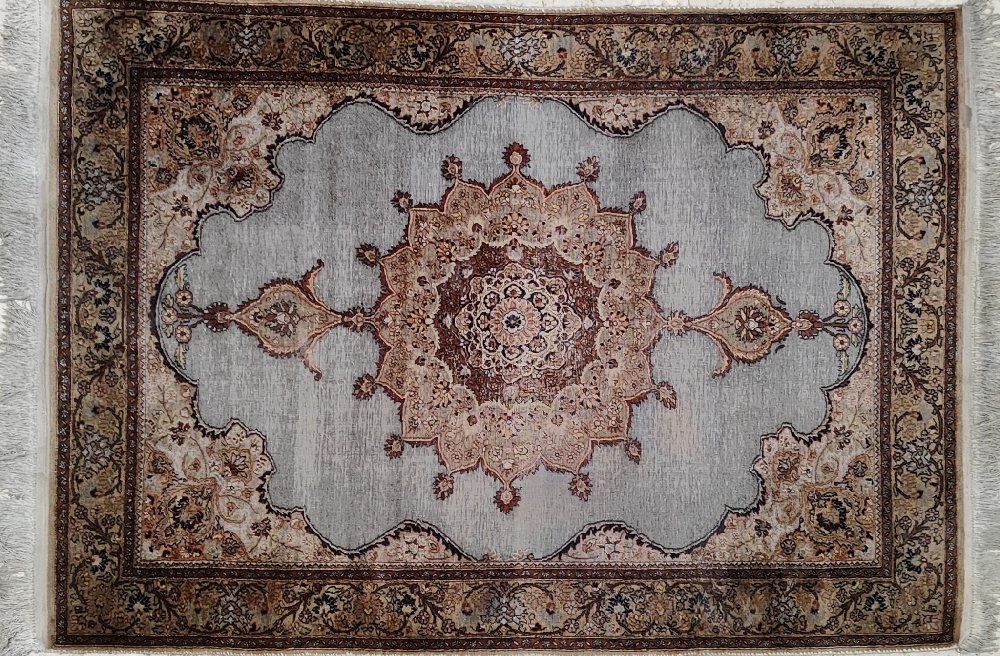 Persian hand woven silk rug, pale blue medallion centre, 180x128cms