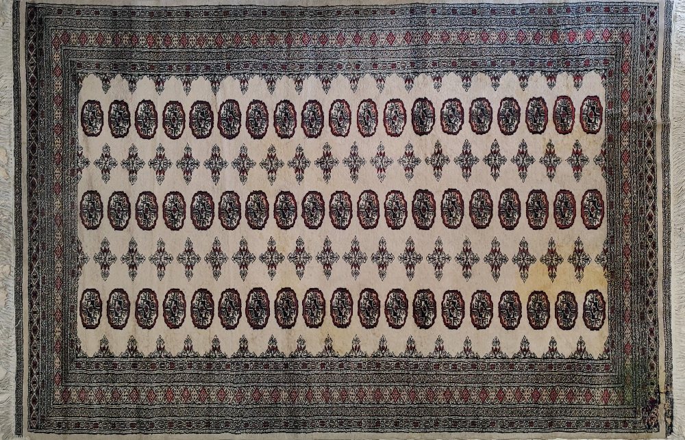 Persian Bochara rug red medalliona, baige ground, 280x165cms (corner repair)