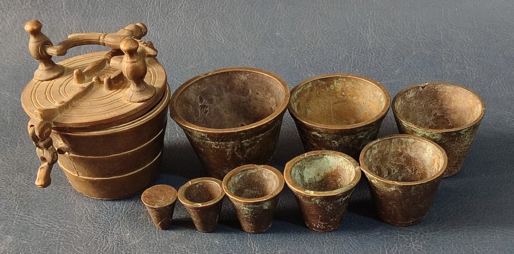 8, Bronze graduated weights in bucket case, ca 1970