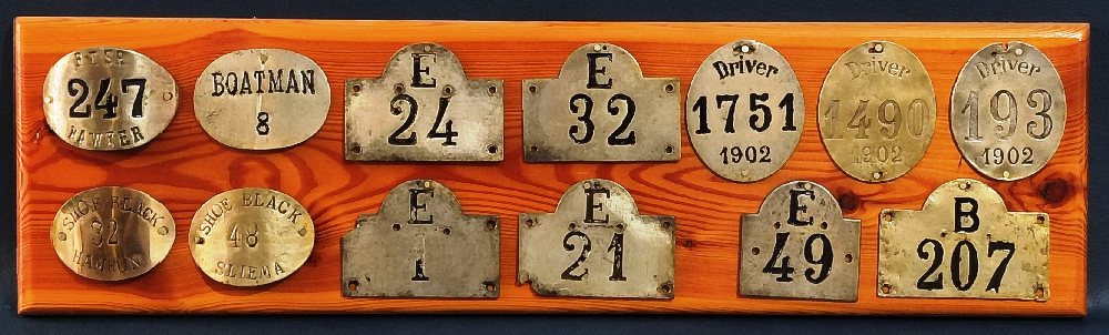 13, Maltese trade license metal plates: Boatman, Driver, Shoe Black, Fish (on wood plaque)