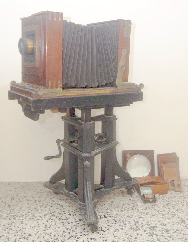 Studio Camera large format mahogany and brass photographic camera, on ebonised tripod legs, ca 1900,