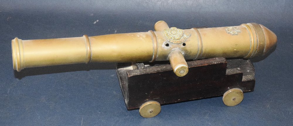 Brass Model canon on wooden carriage, 46cms