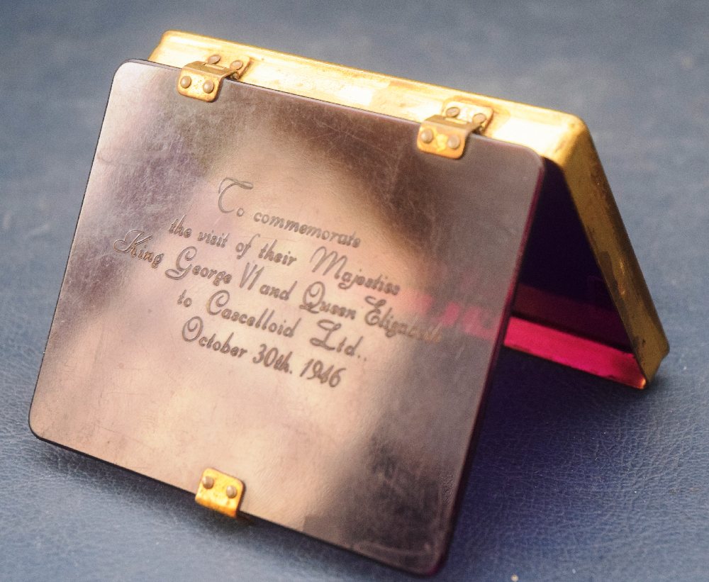 KGVI & QE visir to Celluloid Limited October 1946, purple celluloid and brass mounted cigarette box