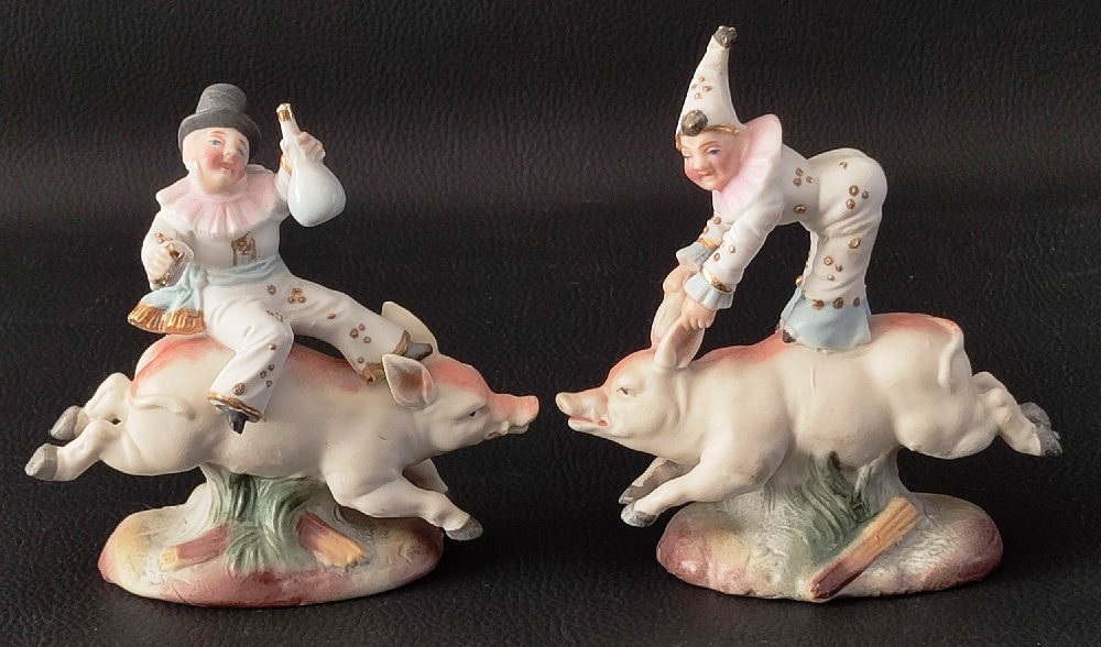 19th C. Bisque china figures of jesters riding pigs